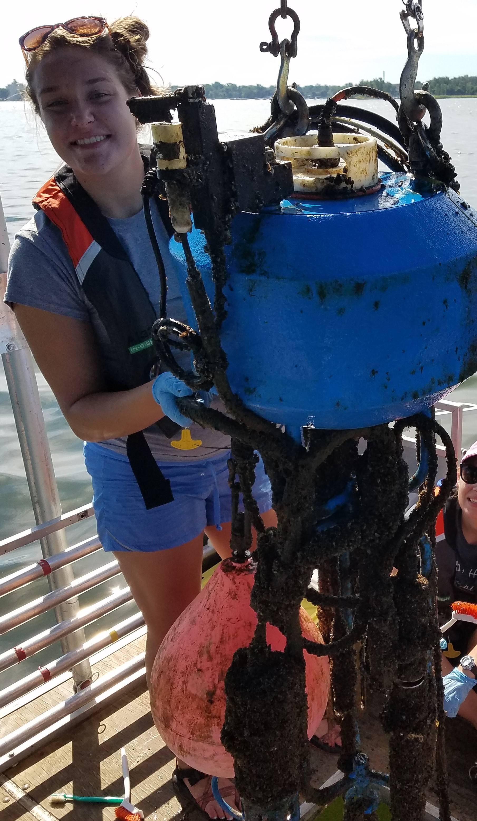 Macy Doster holding subsurface buoy sensors